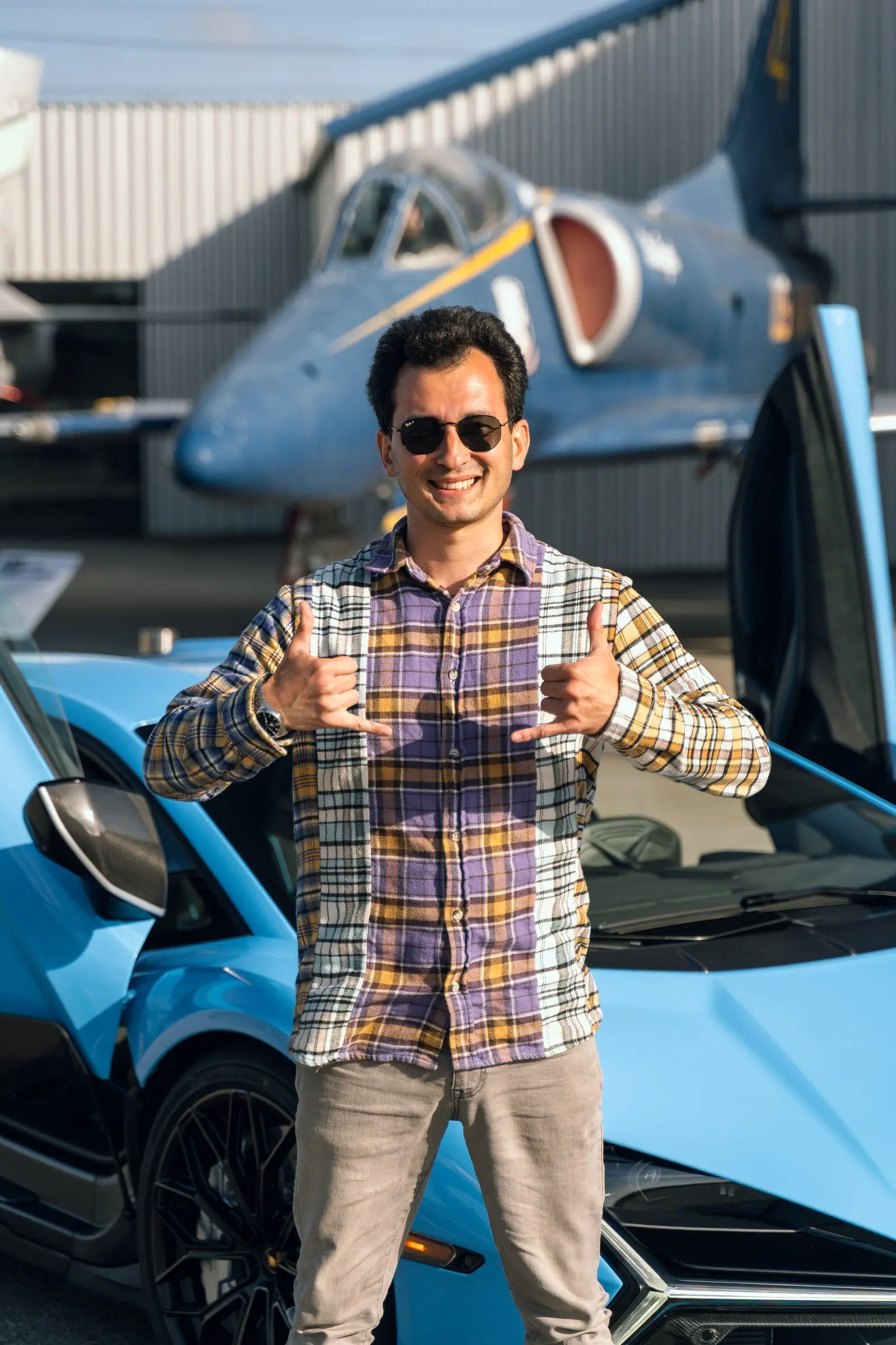 Alan giving a thumbs up in front of the Revuelto and a blue-and-yellow jet