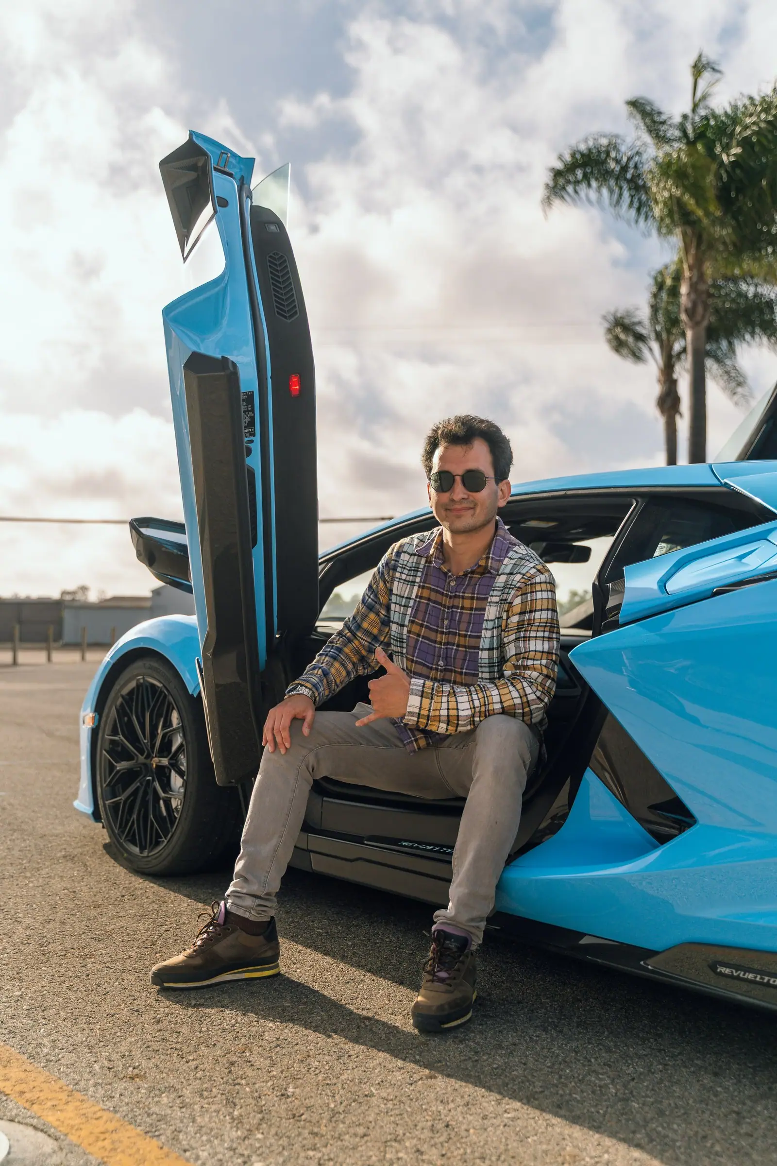 Alan sitting in the open door of the Lamborghini Revuelto