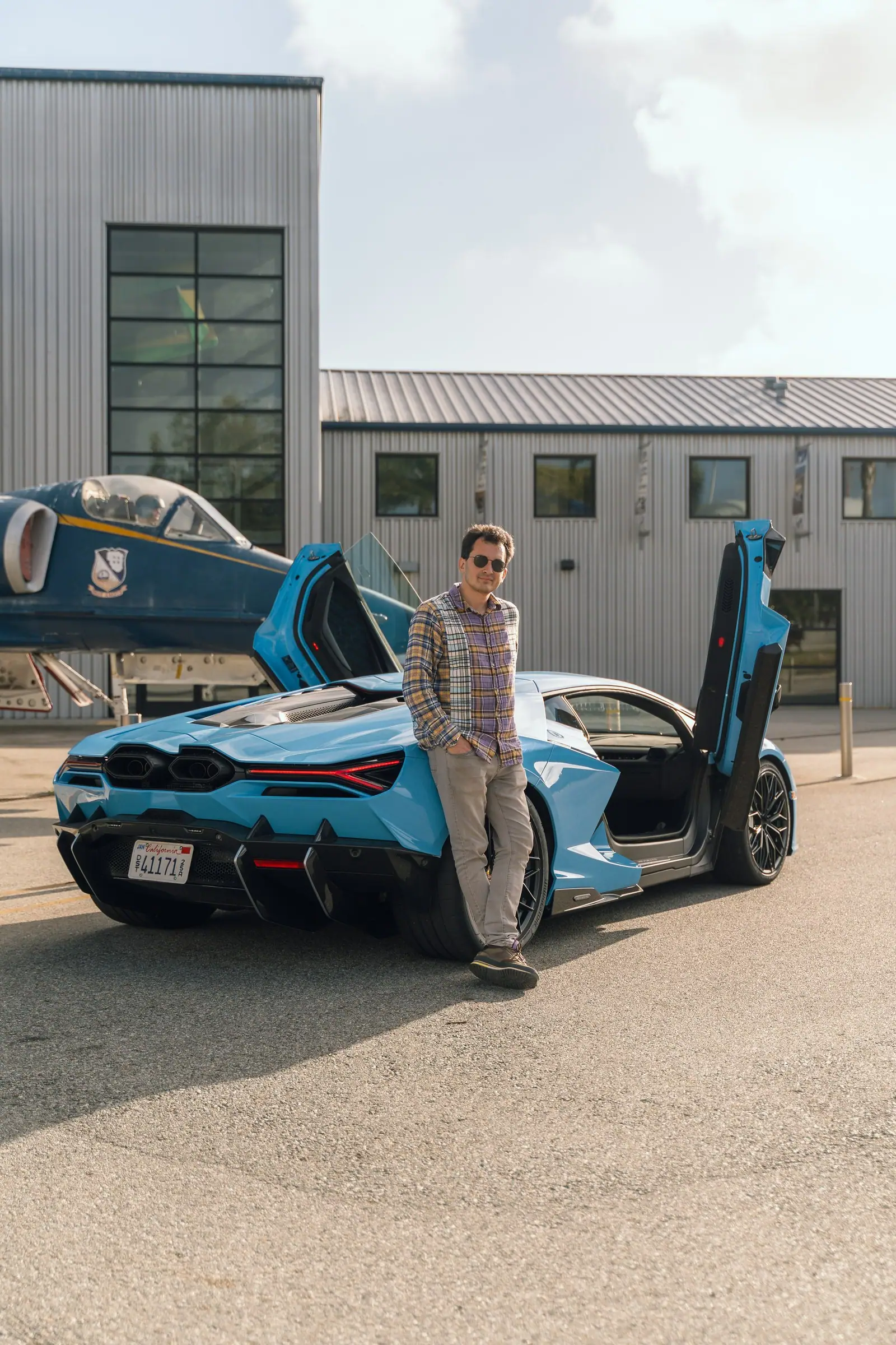 Rear three-quarter view of the Revuelto with Alan standing beside it