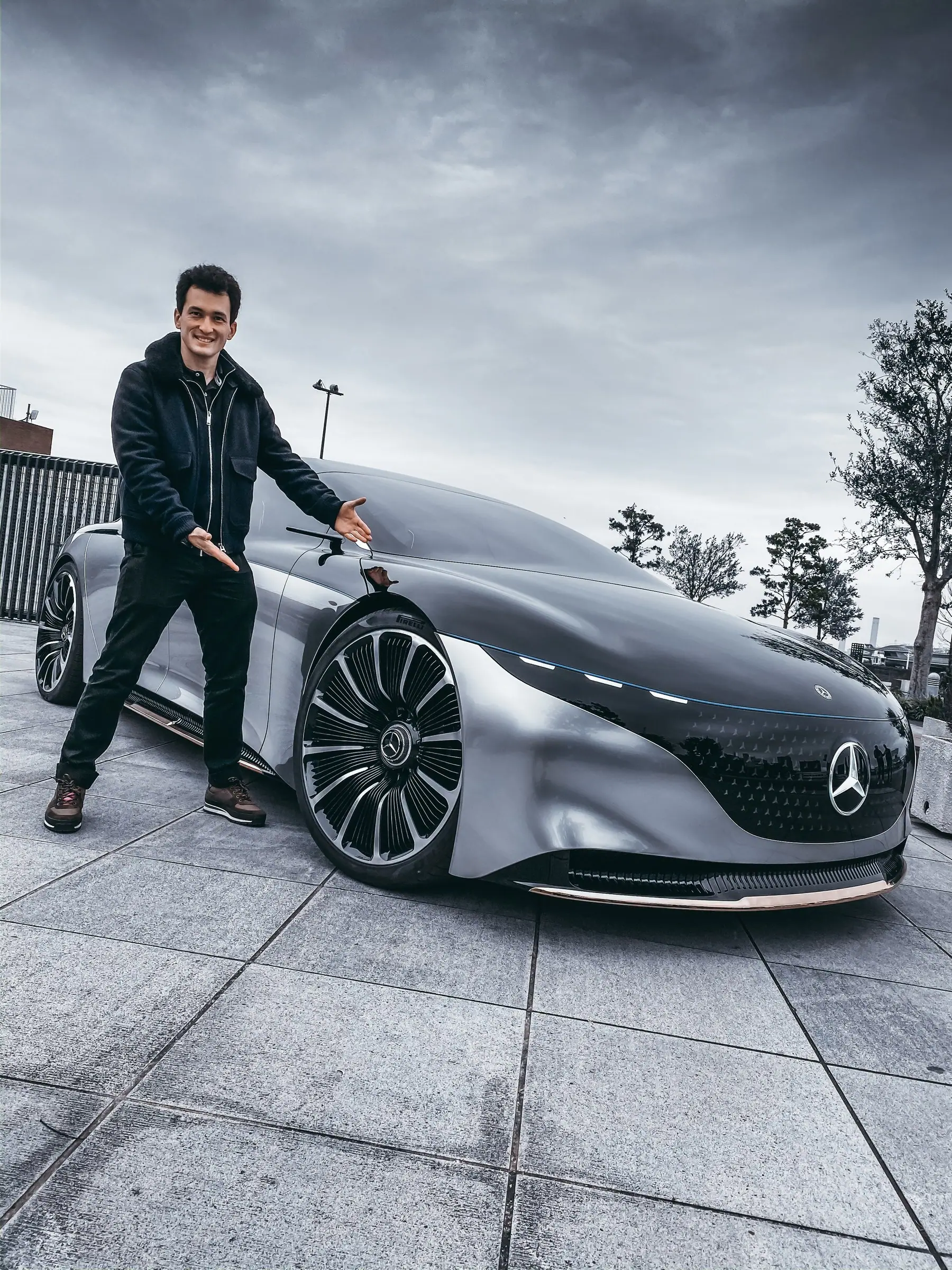Alan beside the silver Mercedes-Benz Vision One-Eleven concept under a cloudy sky